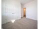 Carpeted bedroom with a closet, white doors, and ample natural light from a window at 9236 Kavanaugh Dr, Indianapolis, IN 46239
