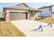 Beautiful one-story home with a wide driveway, covered porch, and manicured lawn at 9236 Kavanaugh Dr, Indianapolis, IN 46239