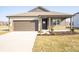 Charming single-story home with a two-car garage, covered porch, and freshly landscaped front yard at 9236 Kavanaugh Dr, Indianapolis, IN 46239