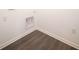 A laundry room area has wood flooring and white walls with hookups at 9236 Kavanaugh Dr, Indianapolis, IN 46239