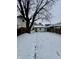 Snowy backyard with a view of the house and wooden fence at 1125 Laurel St, Indianapolis, IN 46203