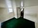 Bedroom with green carpet and access to another room at 1125 Laurel St, Indianapolis, IN 46203