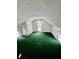 Large attic bedroom with green carpet and multiple windows at 1125 Laurel St, Indianapolis, IN 46203