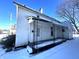 White house exterior with front porch, snow on the ground at 1125 Laurel St, Indianapolis, IN 46203