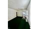 Living room with green carpet and access to other rooms at 1125 Laurel St, Indianapolis, IN 46203