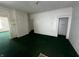 Living room with green carpet and built-in shelving at 1125 Laurel St, Indianapolis, IN 46203