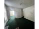 Large living room with green carpet and multiple doorways at 1125 Laurel St, Indianapolis, IN 46203