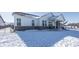 Exterior view of a two-story house with brick and siding, covered patio, and snowy yard at 19046 Beverly Shones Ln, Noblesville, IN 46062