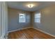 Bedroom featuring hardwood floors, two windows, and neutral walls at 2010 N Irwin St, Indianapolis, IN 46219