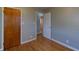 Bedroom featuring hardwood floors, a wood door, and neutral walls at 2010 N Irwin St, Indianapolis, IN 46219
