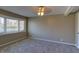 Neutral bedroom featuring a ceiling fan, fresh carpeting, and a large window overlooking the yard at 2010 N Irwin St, Indianapolis, IN 46219