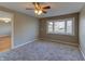 Comfortable bedroom with new carpeting, a ceiling fan, and a bright window for natural light at 2010 N Irwin St, Indianapolis, IN 46219