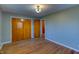 Neutral bedroom with wood floors, lighting fixture and access to hallway at 2010 N Irwin St, Indianapolis, IN 46219
