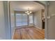 Charming dining room featuring hardwood floors, a stylish chandelier, and convenient access to the kitchen at 2010 N Irwin St, Indianapolis, IN 46219