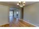 Charming dining room featuring hardwood floors, elegant chandelier, and open archway at 2010 N Irwin St, Indianapolis, IN 46219