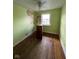 Bedroom with hardwood floors, green walls, and a dresser at 2607 E 12Th St, Indianapolis, IN 46201