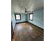 Light blue bedroom with hardwood floors and two windows at 2607 E 12Th St, Indianapolis, IN 46201
