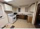 Small kitchen with white appliances and wood cabinets at 2607 E 12Th St, Indianapolis, IN 46201