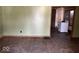 Hardwood floors and green walls in the living room, showing access to the kitchen at 2607 E 12Th St, Indianapolis, IN 46201