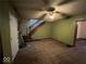 Living room with hardwood floors, a staircase, and green walls at 2607 E 12Th St, Indianapolis, IN 46201