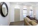 Bright entryway with hardwood floors, mirror, and seating area at 2811 Grandview Ln, Greenwood, IN 46143