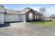 The house has an attached garage, brick accents, and a paved driveway at 2811 Grandview Ln, Greenwood, IN 46143