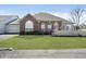 Charming brick home featuring arched windows, a well-manicured lawn, and inviting curb appeal at 2811 Grandview Ln, Greenwood, IN 46143