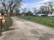 Long driveway leading to a home with additional buildings, offering ample space and parking at 2920 Newhart St, Indianapolis, IN 46217