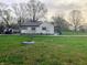 Side view of home showing the expansive yard and additional outside storage at 2920 Newhart St, Indianapolis, IN 46217