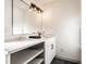 Elegant bathroom features a large mirror, modern lighting, and quartz countertops at 404 N Gray St, Indianapolis, IN 46201