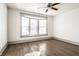 Bright bedroom with wood floors, ceiling fan and a bay window offering lots of natural light at 404 N Gray St, Indianapolis, IN 46201