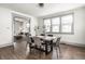 Open-concept dining room features a wood table with stylish chairs and decor, with a view to the living room at 404 N Gray St, Indianapolis, IN 46201