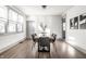 Bright dining room features a modern table, six chairs, hardwood floors, and natural light at 404 N Gray St, Indianapolis, IN 46201