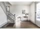 Inviting entryway features hardwood floors, a stylish console table, and a staircase at 404 N Gray St, Indianapolis, IN 46201