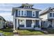Charming two-story home with a cozy front porch and well-maintained lawn at 404 N Gray St, Indianapolis, IN 46201