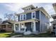 Charming blue two-story home with white trim, inviting front porch and landscaped yard at 404 N Gray St, Indianapolis, IN 46201