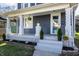 Inviting front porch with classic columns, fresh flowers, and manicured landscaping at 404 N Gray St, Indianapolis, IN 46201