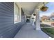 Inviting front porch with classic columns and hanging flower baskets at 404 N Gray St, Indianapolis, IN 46201