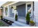 Inviting front porch with classic columns, fresh flowers, and manicured landscaping at 404 N Gray St, Indianapolis, IN 46201