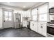 Bright kitchen featuring white cabinets, stainless steel appliances, and modern fixtures at 404 N Gray St, Indianapolis, IN 46201