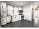 Well-lit kitchen with stainless steel appliances, modern cabinetry and dark tile floors at 404 N Gray St, Indianapolis, IN 46201