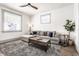 Bright living room with a comfortable gray couch, modern coffee table, and a leafy green plant at 404 N Gray St, Indianapolis, IN 46201
