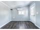A well-lit room with vinyl plank flooring, neutral walls, and air conditioning unit at 404 N Gray St, Indianapolis, IN 46201