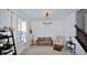 Living room features a brown leather couch, guitar, and a large window at 6823 Aster Dr, Pendleton, IN 46064