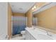 Bathroom featuring a double sink vanity, a large mirror, and a shower with a blue patterned curtain at 7414 Glen Park Way, Indianapolis, IN 46259
