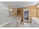 This bathroom features a soaking tub, stand up shower, and double sinks at 7414 Glen Park Way, Indianapolis, IN 46259