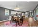 Dining room with modern chandelier, opens to kitchen, perfect for gatherings at 7414 Glen Park Way, Indianapolis, IN 46259