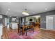 Elegant dining room open to kitchen features stylish chandelier and natural light at 7414 Glen Park Way, Indianapolis, IN 46259