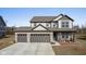 Beautiful two-story home featuring a three-car garage, covered porch, and manicured landscaping at 7414 Glen Park Way, Indianapolis, IN 46259