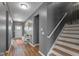 The foyer area has hard wood floors, stairs, and a bench with decorations at 7414 Glen Park Way, Indianapolis, IN 46259